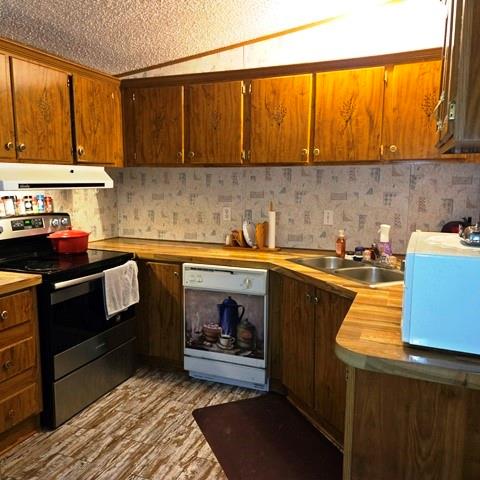 108 Elm Street Mabank, TX 75156 - Photo 9 of 22 a kitchen with a sink cabinets and appliances