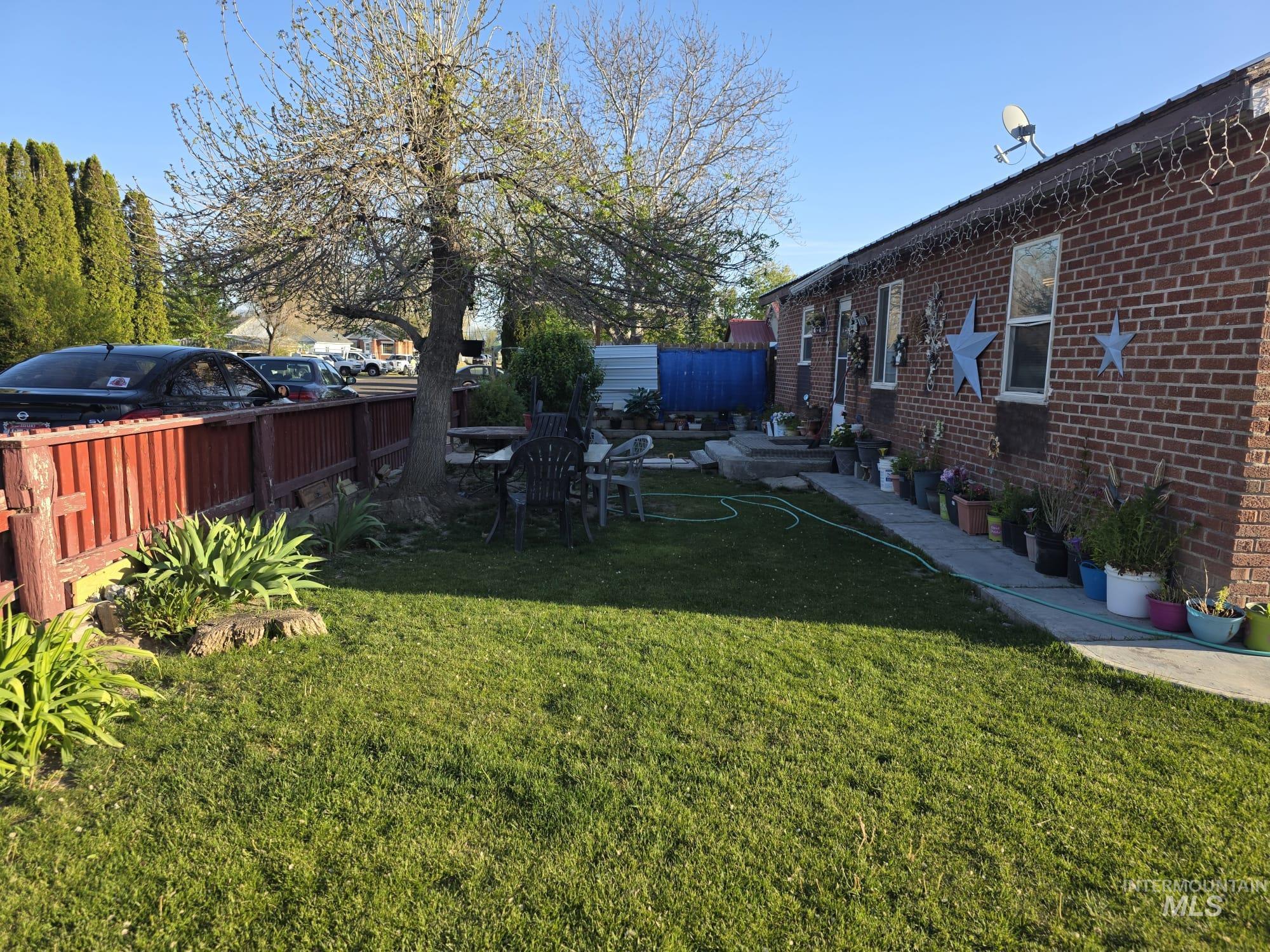 1851 K Street Heyburn, ID 83336 - Photo 2 of 10 Brick exterior featuring multiple windows and a concrete walkway
