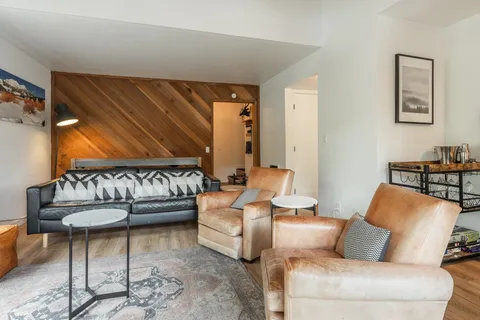 a living room with furniture and a lamp