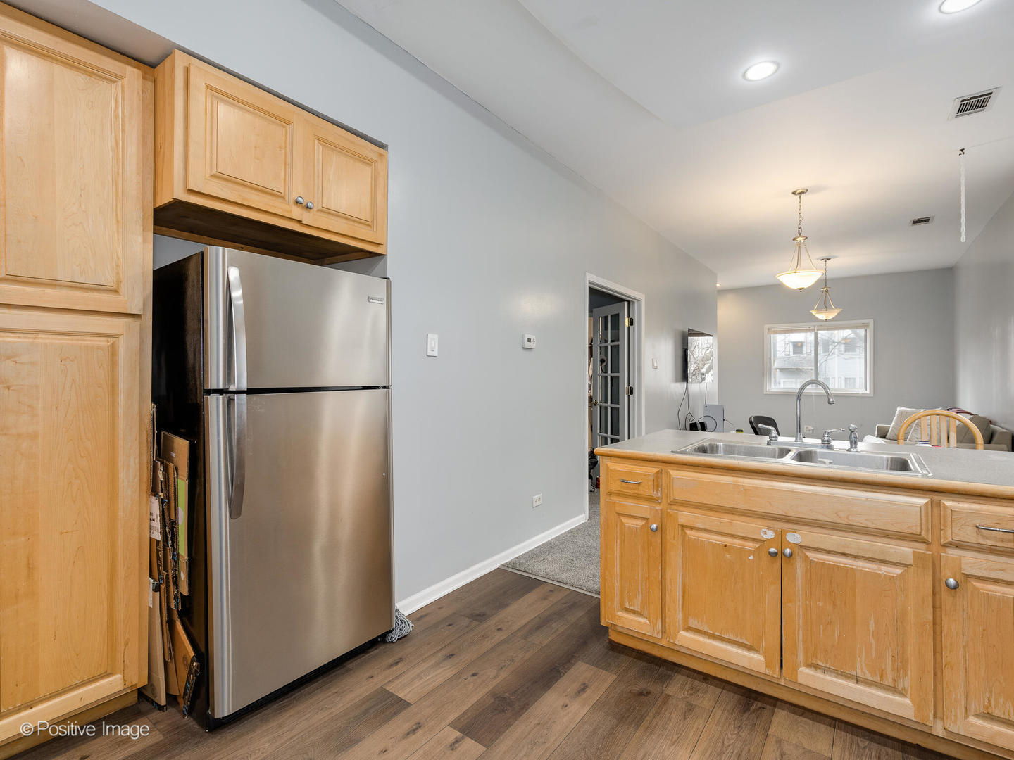 2620 West Homer Street Chicago, IL 60647 - Photo 13 of 31 a kitchen with kitchen island a refrigerator sink and cabinets