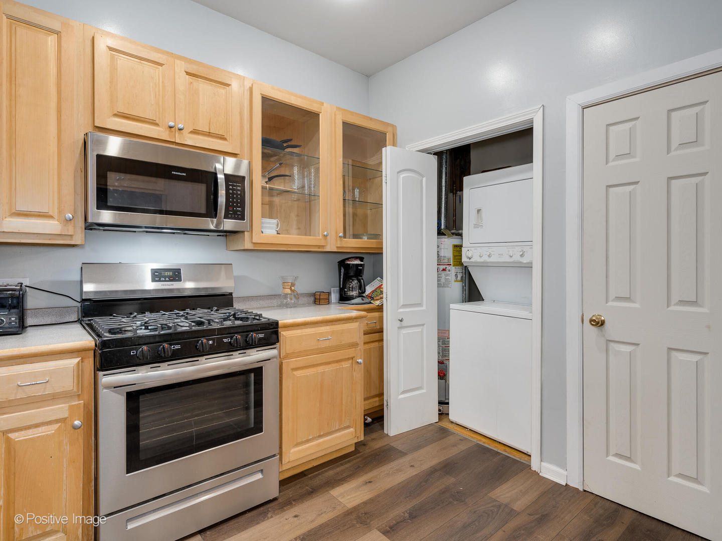 2620 West Homer Street Chicago, IL 60647 - Photo 14 of 31 a kitchen with stainless steel appliances granite countertop a stove and a microwave