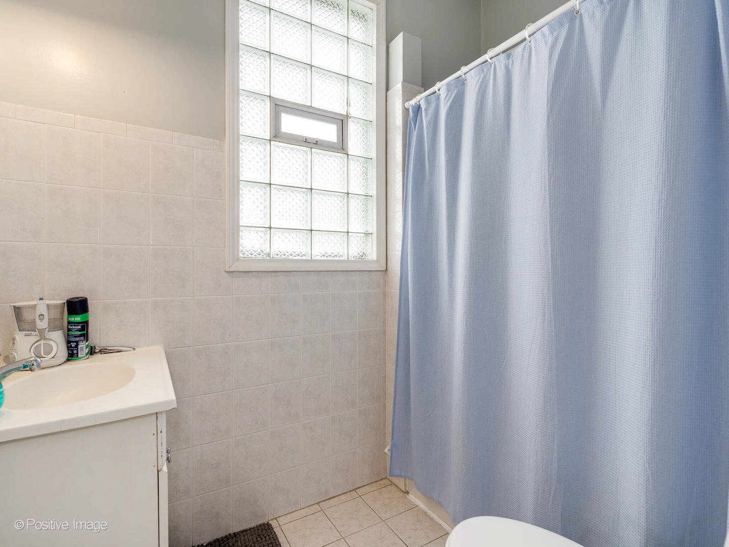 2620 West Homer Street Chicago, IL 60647 - Photo 16 of 31 a bathroom with a sink and a mirror