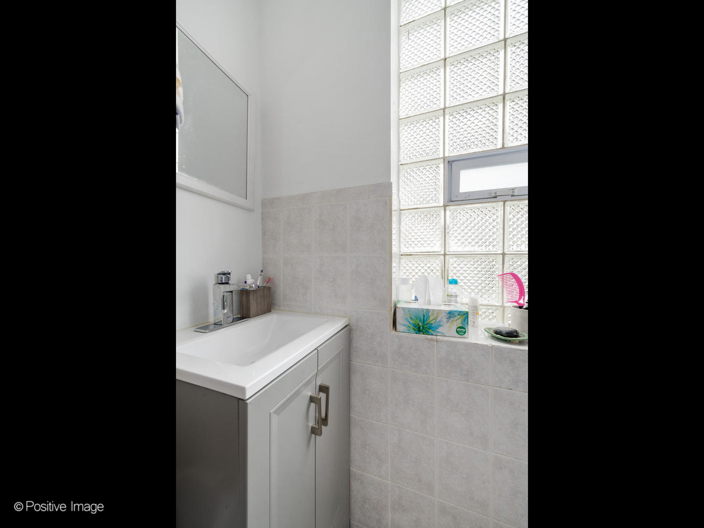 2620 West Homer Street Chicago, IL 60647 - Photo 24 of 31 a bathroom with a sink and a vanity