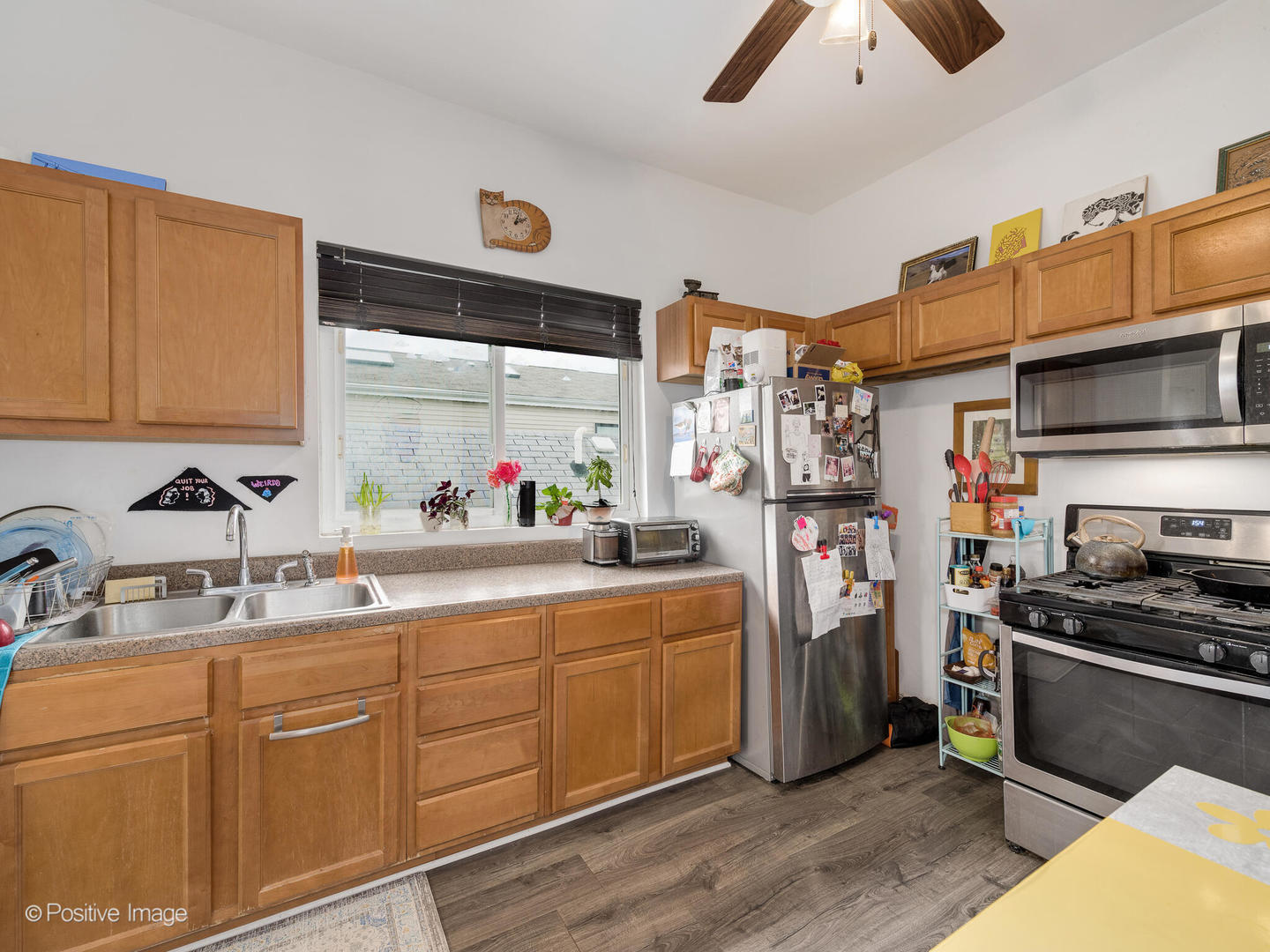 2620 West Homer Street Chicago, IL 60647 - Photo 5 of 31 a kitchen with stainless steel appliances granite countertop a sink stove and refrigerator