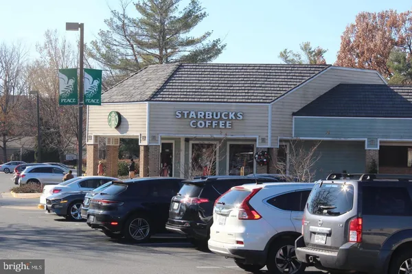 a front view of a building with outdoor seating