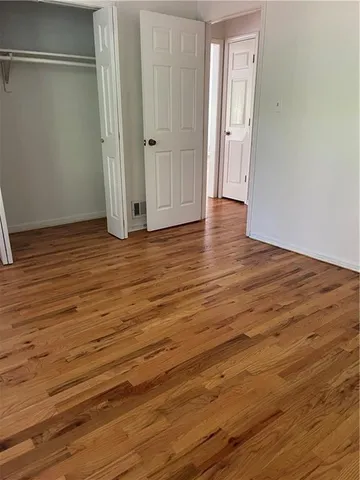 a view of a room with wooden floor