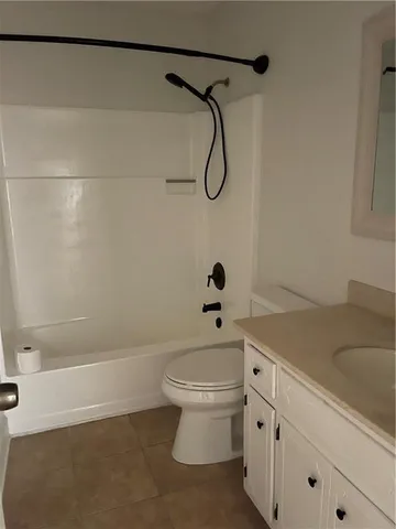 a bathroom with a shower a toilet and a sink
