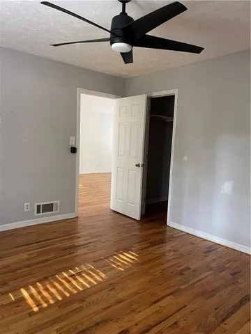 a view of an empty room with wooden floor