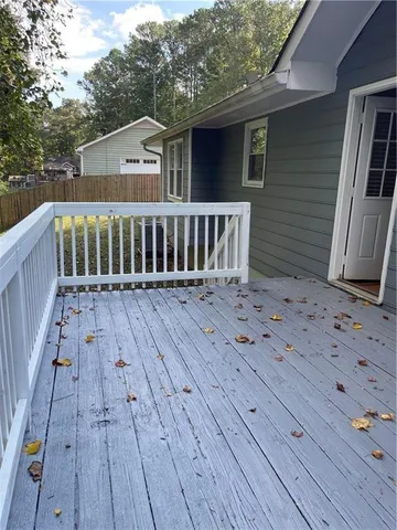 a view of a wooden deck with a yard