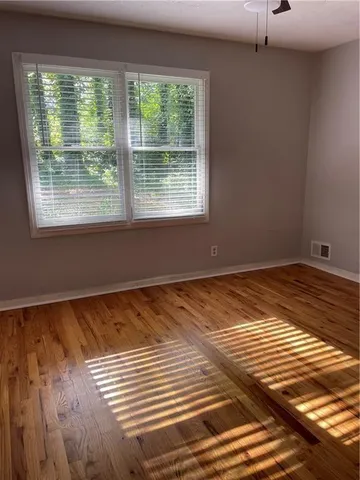 a view of a room with wooden floor and chair