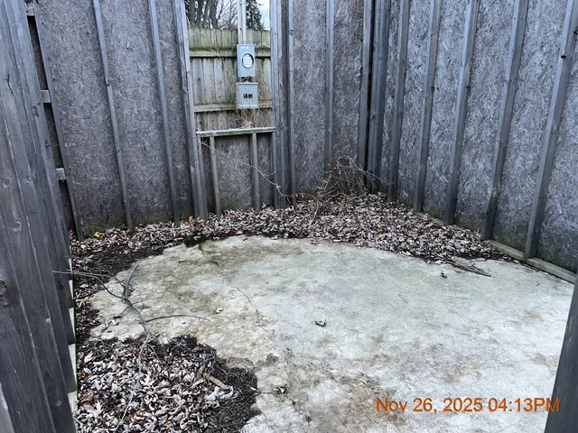 a backyard of a house with barbeque oven and outdoor seating