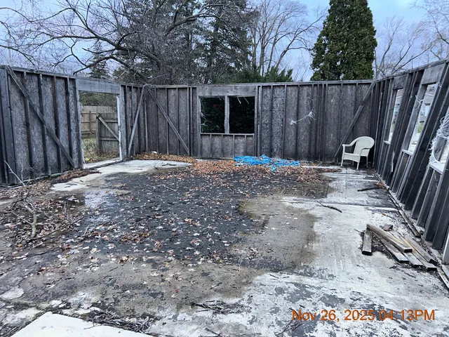 a view of a wooden door with a tree in the background