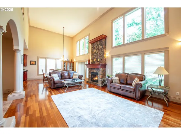 a living room with fireplace furniture and a large window