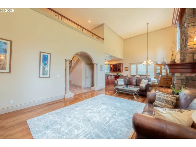 a living room with furniture a rug and a chandelier