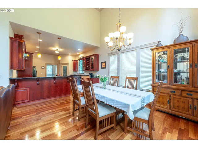 a view of a dining room with furniture and a chandelier