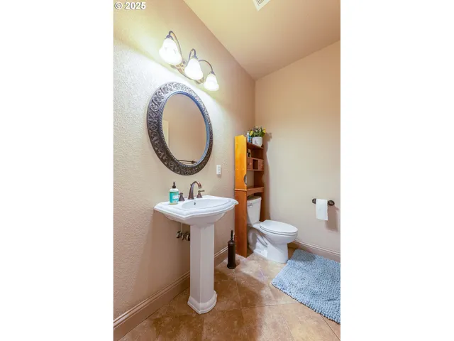 a bathroom with a toilet a sink and a mirror