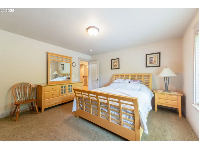 a bedroom with a bed and a chair