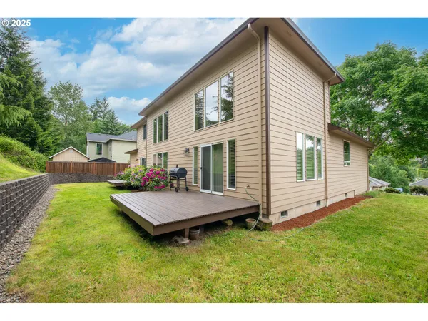 a view of a house with a yard and sitting area