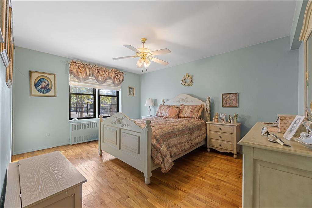 6901 Narrows Avenue, Unit 1C Brooklyn, NY 11209 - Photo 12 of 22 a bedroom with a bed and a chandelier