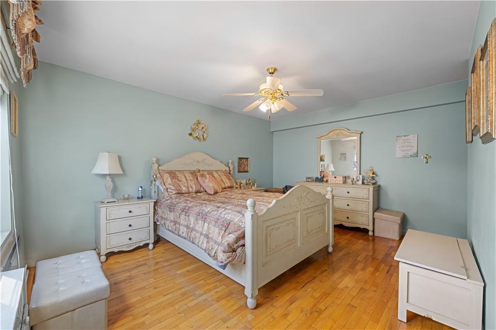 6901 Narrows Avenue, Unit 1C Brooklyn, NY 11209 - Photo 13 of 22 a bed room with a bed and a chandelier