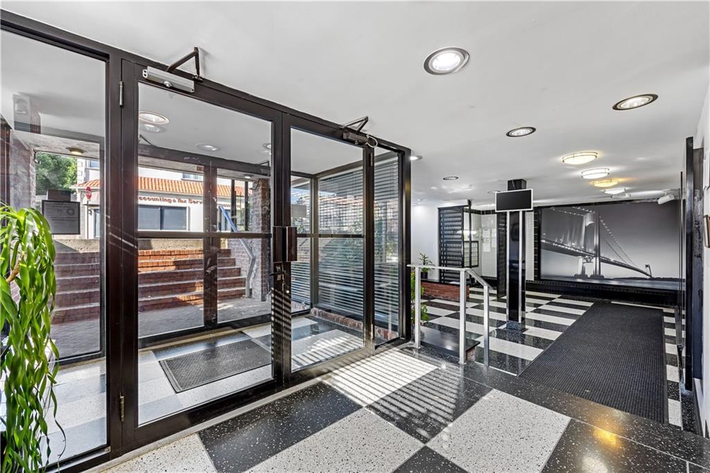 6901 Narrows Avenue, Unit 1C Brooklyn, NY 11209 - Photo 17 of 22 a room with gym equipment and a large window