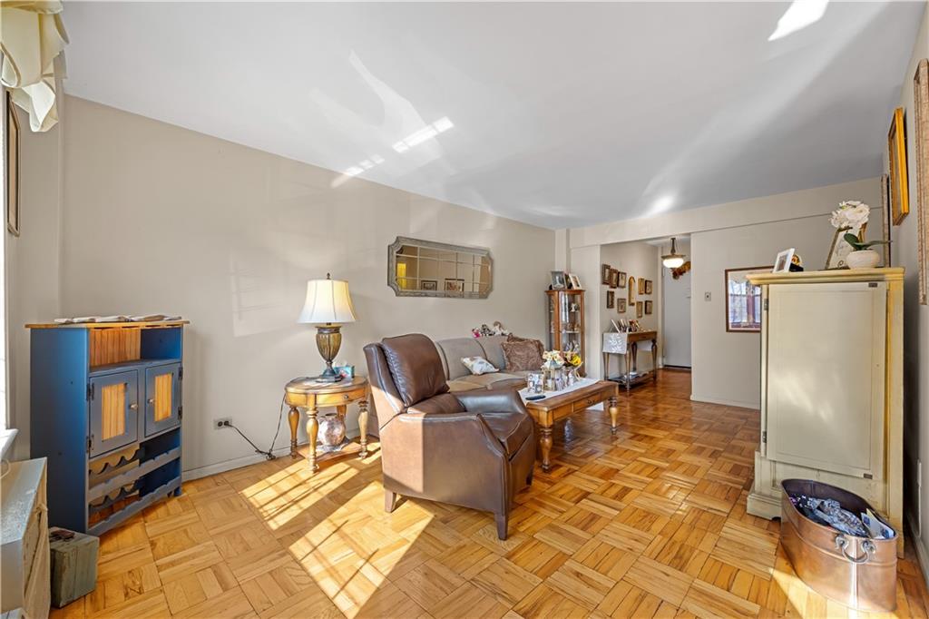 6901 Narrows Avenue, Unit 1C Brooklyn, NY 11209 - Photo 5 of 22 a living room with furniture and a flat screen tv