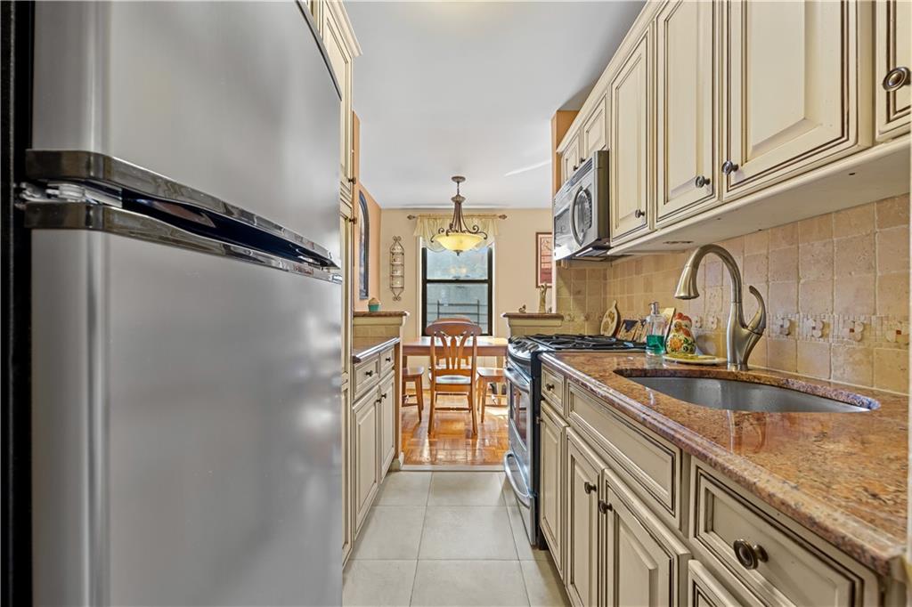 6901 Narrows Avenue, Unit 1C Brooklyn, NY 11209 - Photo 8 of 22 a kitchen with stainless steel appliances granite countertop a refrigerator and a sink