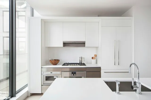 a kitchen with stainless steel appliances a sink and a stove