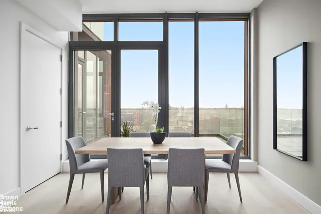 a dining room with furniture window and wooden floor