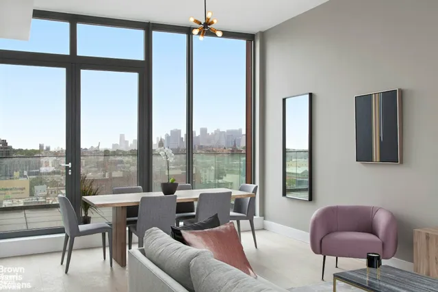 a living room with furniture and a floor to ceiling window
