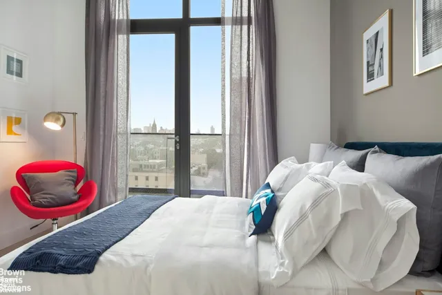 a bedroom with a large bed and a large window