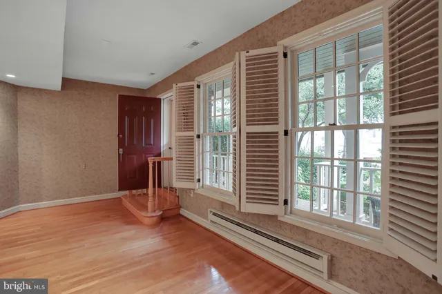 a kitchen with stainless steel appliances granite countertop a sink a stove cabinets and wooden floor