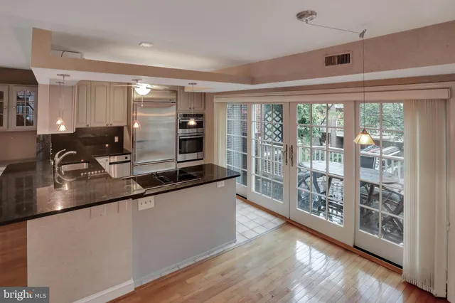 a kitchen with stainless steel appliances granite countertop a sink stove and cabinets