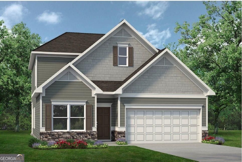 a front view of a house with a yard and garage