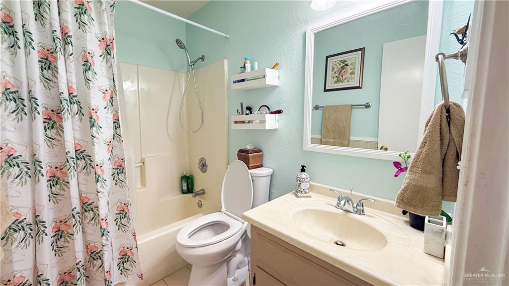 518 Taurus Street Mission, TX 78572 - Photo 12 of 20 a bathroom with a sink toilet and shower