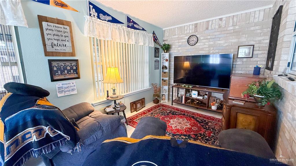 518 Taurus Street Mission, TX 78572 - Photo 13 of 20 a living room with furniture and a flat screen tv