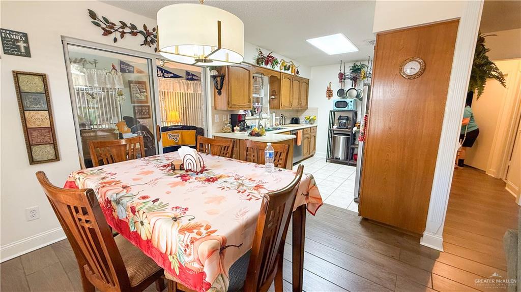 518 Taurus Street Mission, TX 78572 - Photo 4 of 20 a view of a dining room with furniture and wooden floor