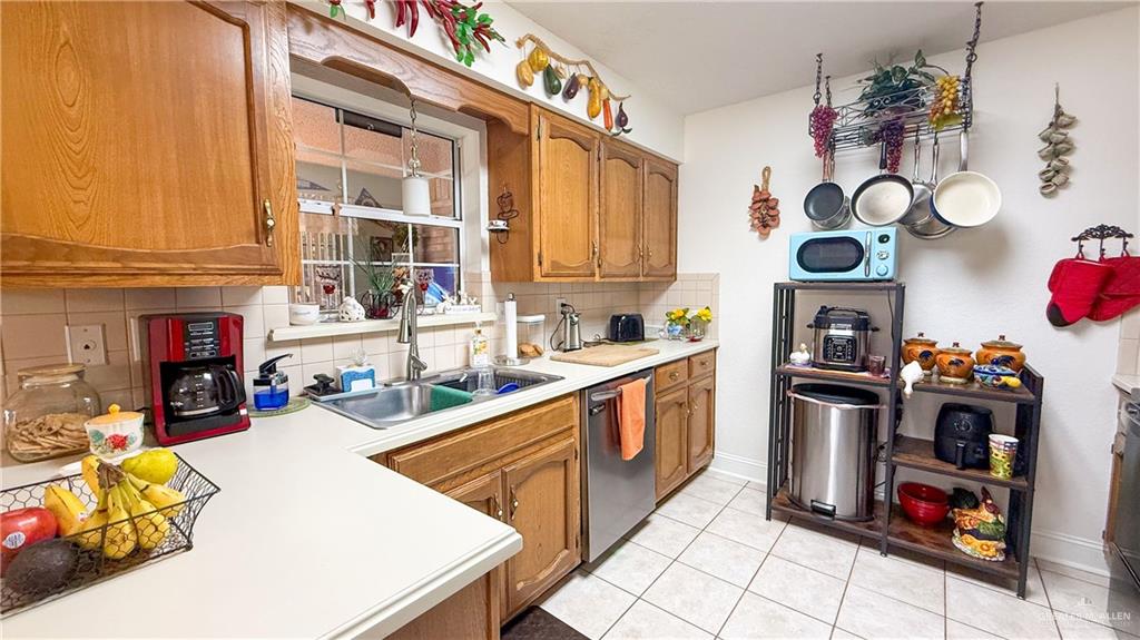 518 Taurus Street Mission, TX 78572 - Photo 5 of 20 a kitchen filled with a white stove top oven and cabinets