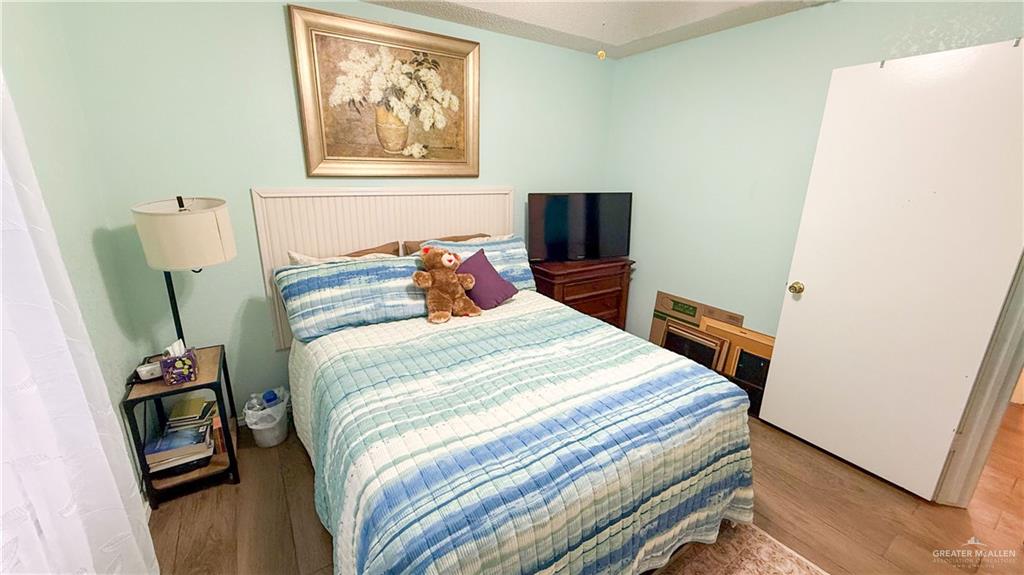 518 Taurus Street Mission, TX 78572 - Photo 7 of 20 a bedroom with a bed and a flat screen tv