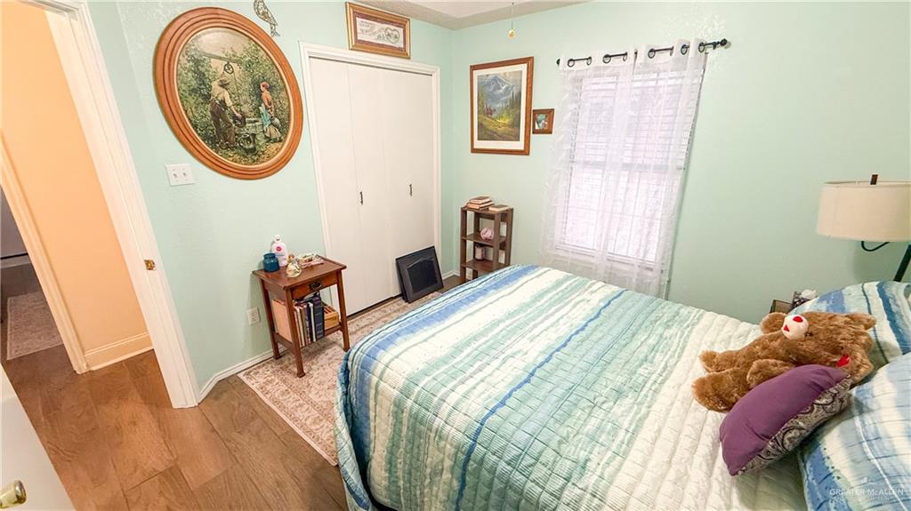 518 Taurus Street Mission, TX 78572 - Photo 8 of 20 a bedroom with a bed and a table in it