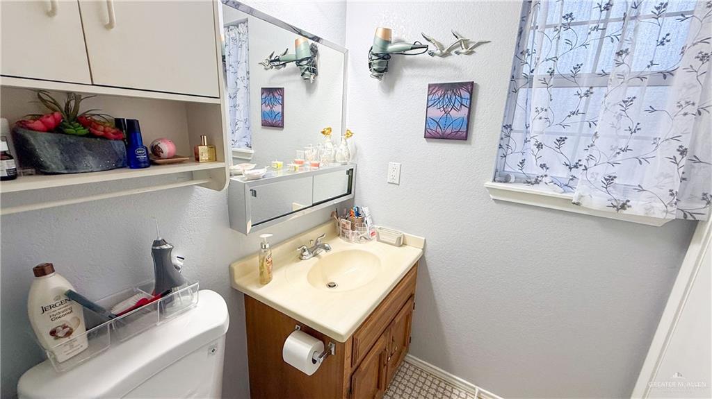 518 Taurus Street Mission, TX 78572 - Photo 9 of 20 a bathroom with a sink and a mirror