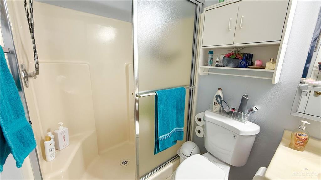 518 Taurus Street Mission, TX 78572 - Photo 10 of 20 a white toilet sitting next to a bathroom sink