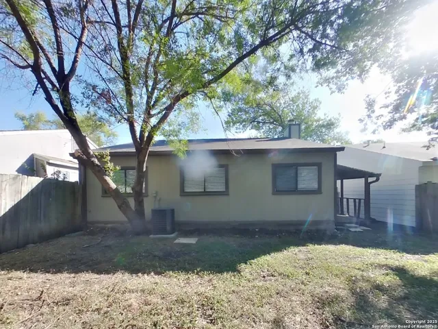 a backyard of a house with table and chairs
