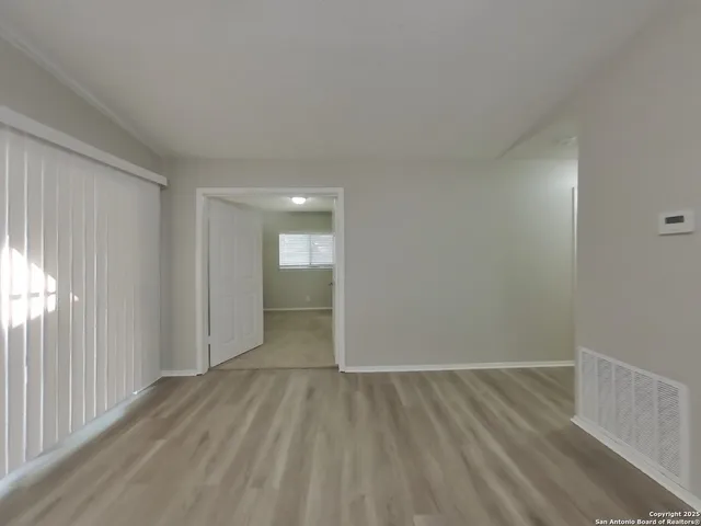 a view of hallway with wooden floor
