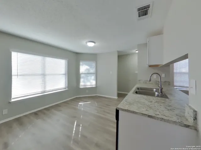 a kitchen with granite countertop a sink and a stove