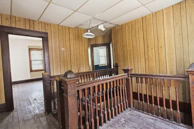 a view of entryway and hall with wooden floor