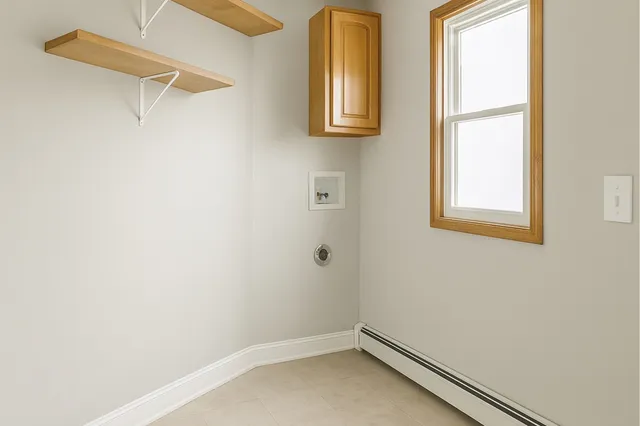a view of a livingroom with wooden floor and stairs