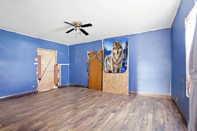 a view of a livingroom with wooden floor and stairs