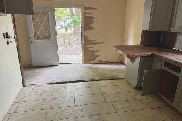 a kitchen with a sink cabinets and window