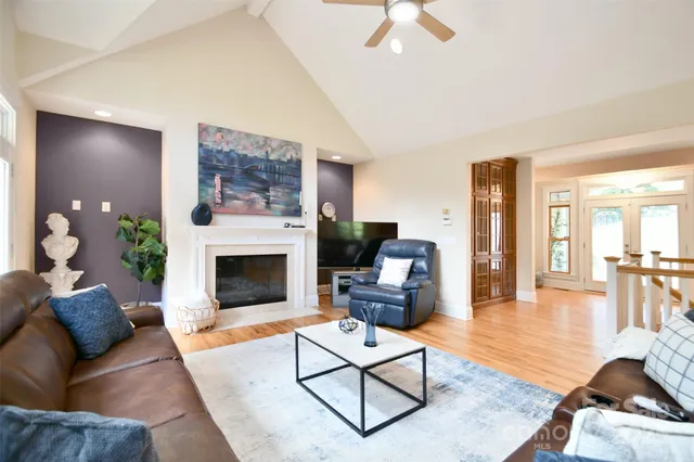 a living room with furniture a fireplace and a flat screen tv